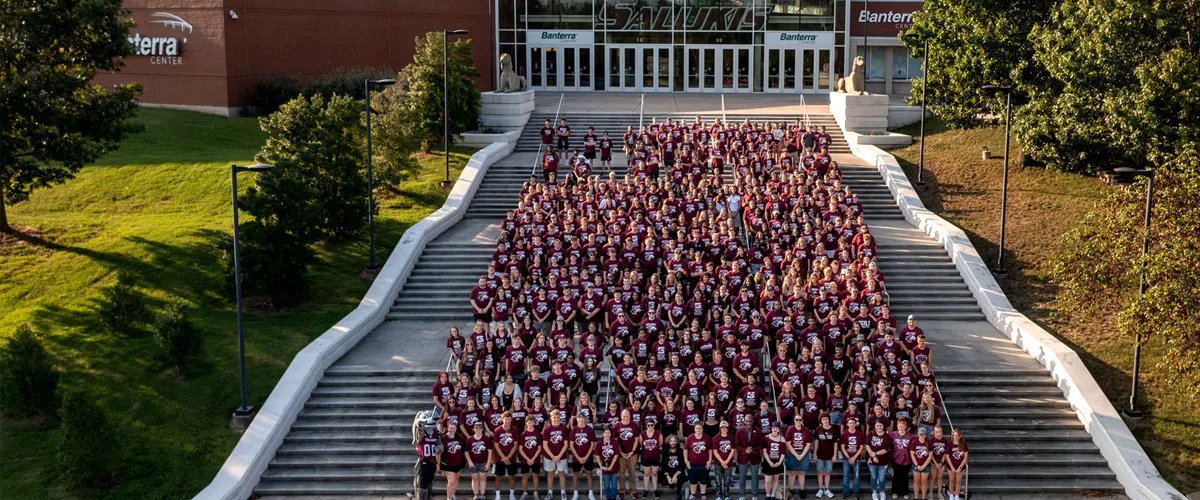 SIU Freshman Class pose together in the stands at Saluki Stadium